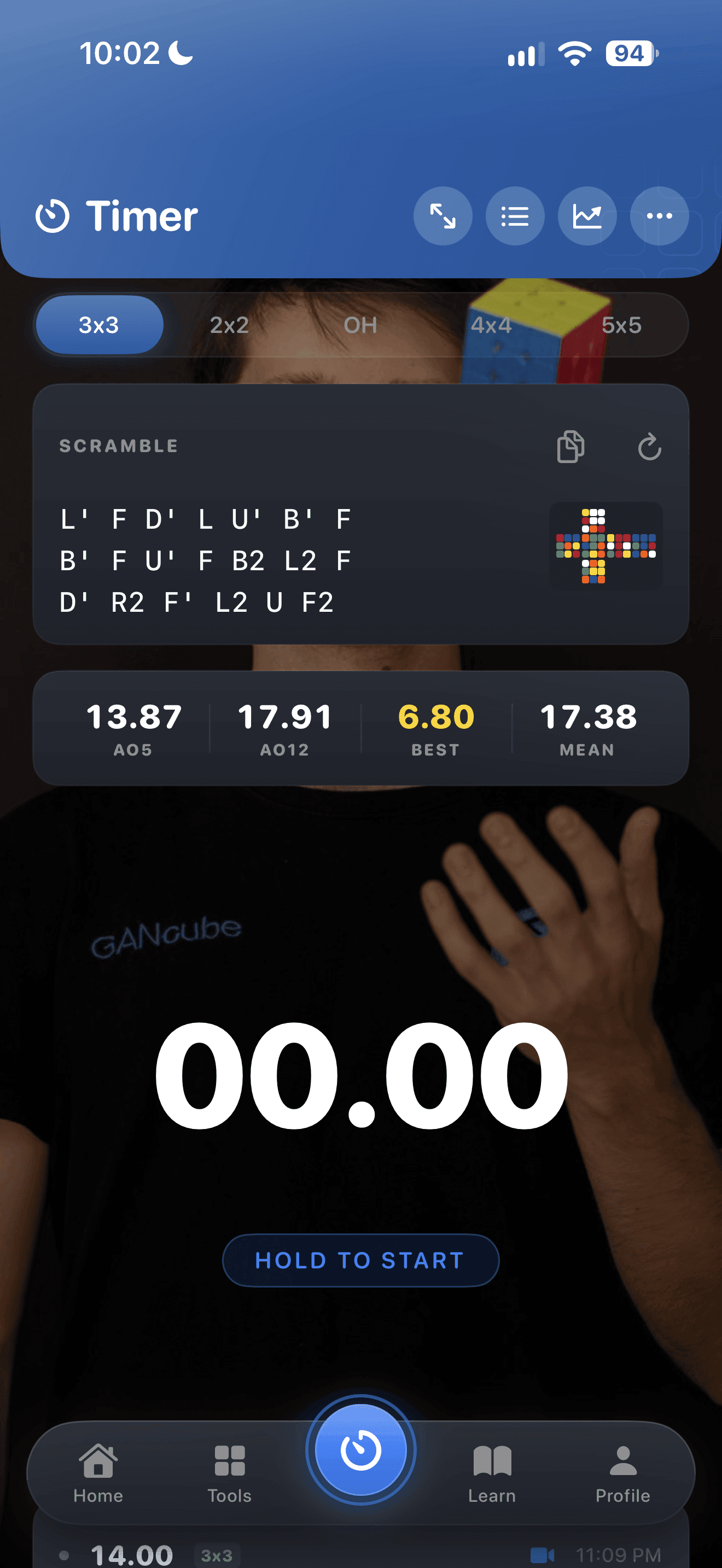 CuberPal timer with a cube-solving video background and scramble